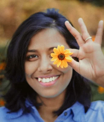Sanmita Mandal Smiling with a flower in her hand